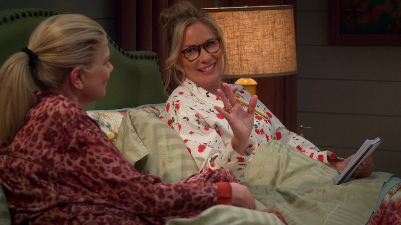 Leanne and Carol sit in bed laughing in Leanne