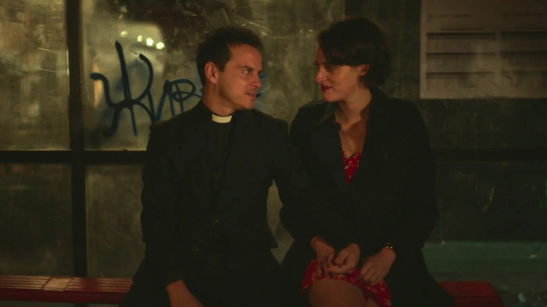 Hot Priest and Fleabag on a bus stop bench looking at each other on Fleabag