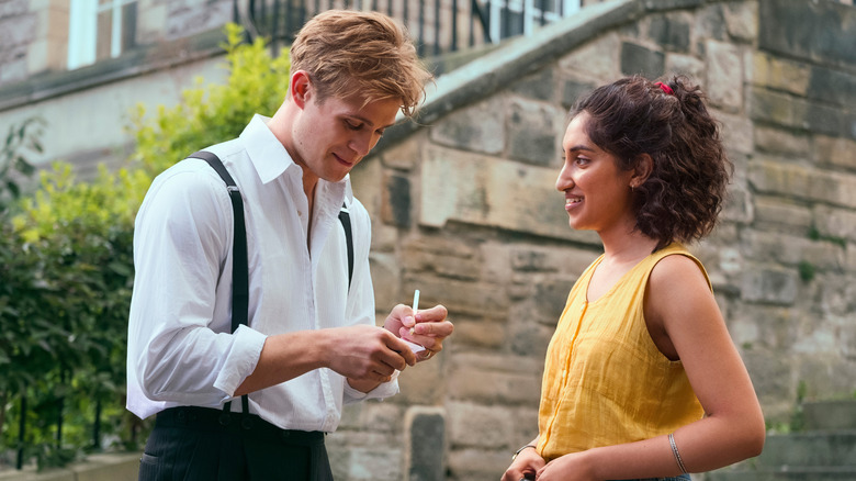 Dex writing his phone number down and Emma smiling on One Day