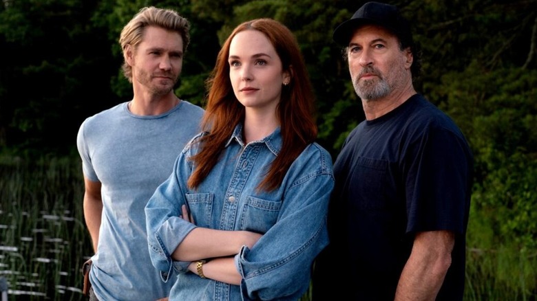 Maggie with her arms crossed flanked by Cal and Sully in "Sullivan's Crossing."