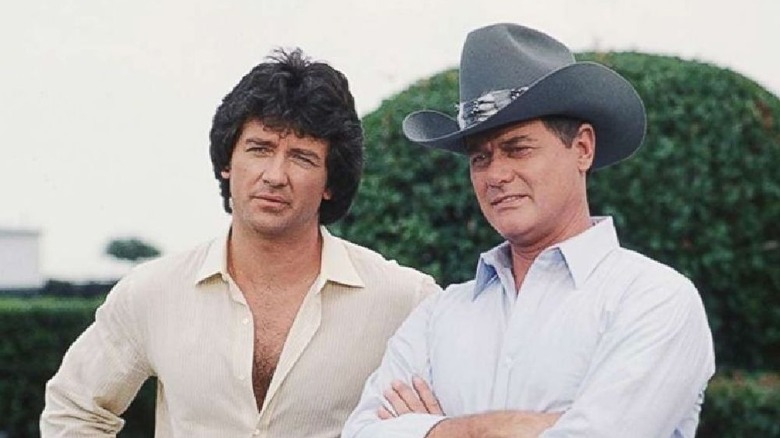 Bobby and J.R. Ewing look at something on their ranch in "Dallas" (1978-1991)