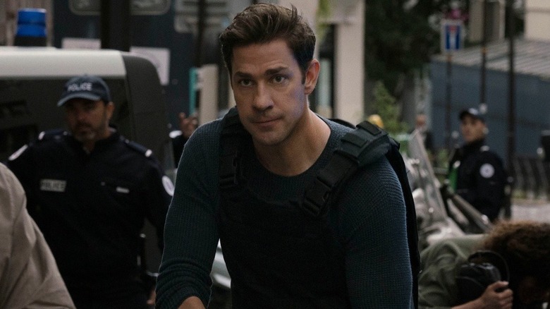 Jack approaches a disaster scene in a bulletproof vest in Jack Ryan