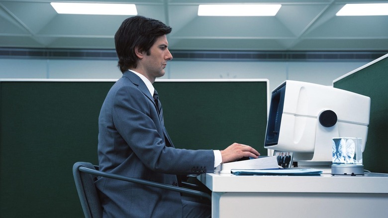 Mark in a cubicle at a computer in Severance