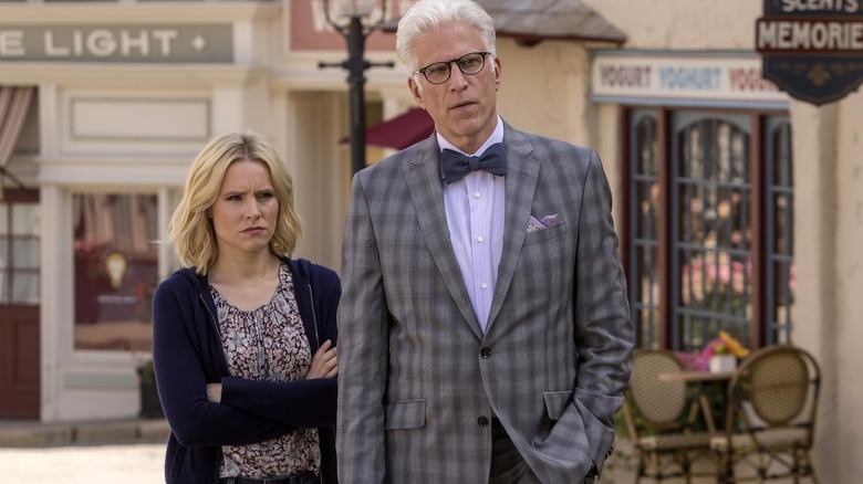 Eleanor stands behind Michael with arms folded in The Good Place