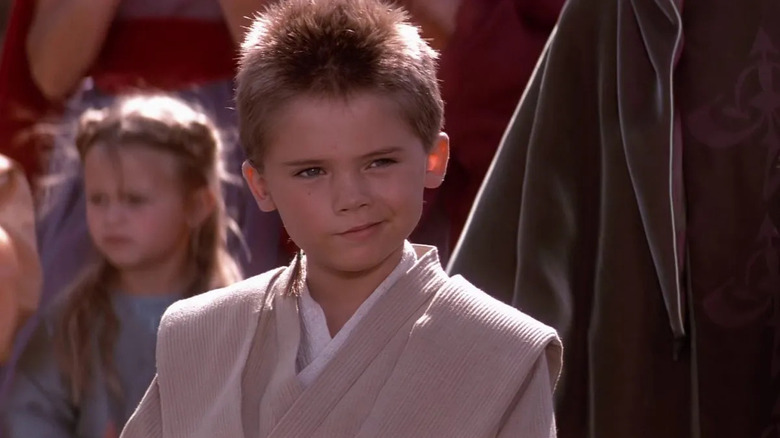 Jedi padawan Anakin Skywalker wears brown jedi robes with short cut hair in "The Phantom Menace"