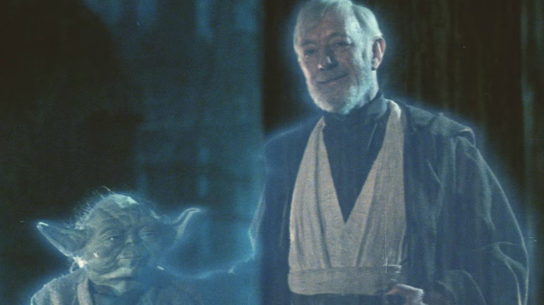 Obi-Wan Kenobi and Yoda wear jedi robes while shrouded in blue light as force ghosts in "Return of the Jedi"