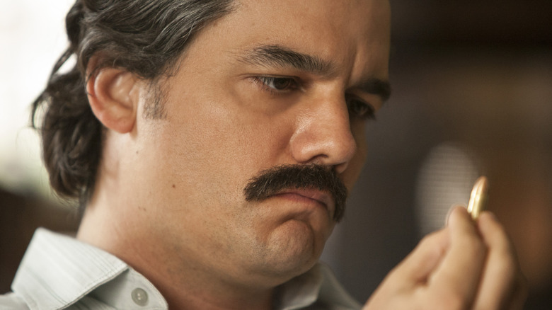 Escobar looking at a bullet
