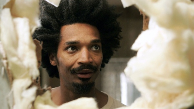 Darnell looks through a hole