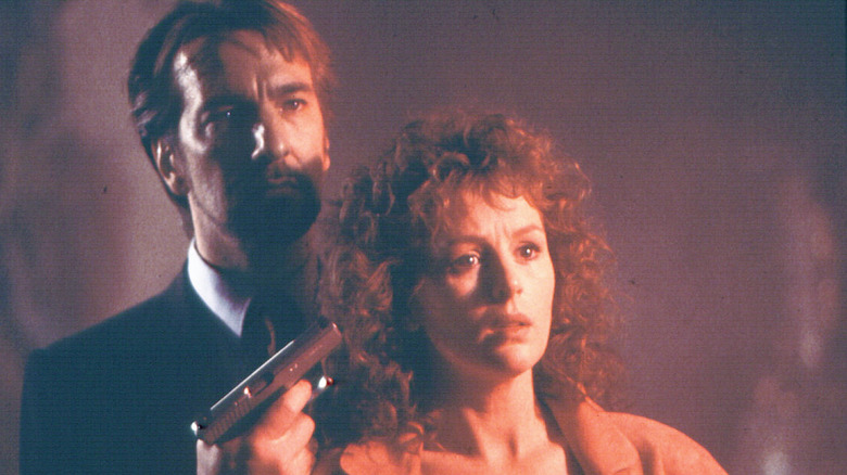 Hans holds gun to Holly's head