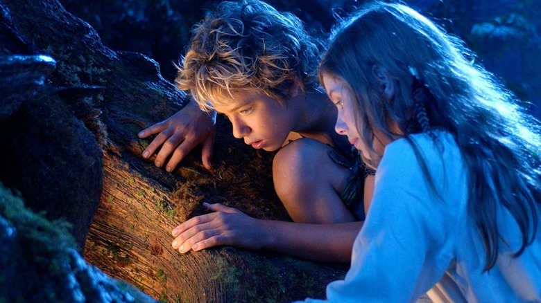 Peter Pan and Wendy peer into a glowing cavern