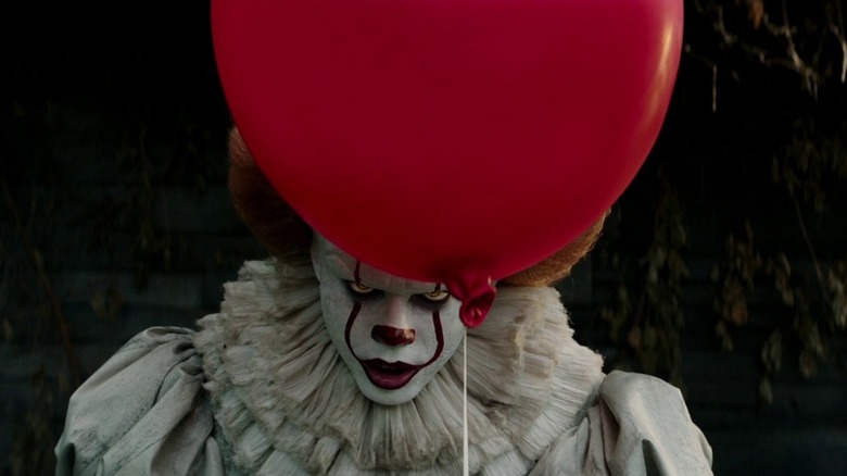 Pennywise lurking behind a balloon in It (2017)