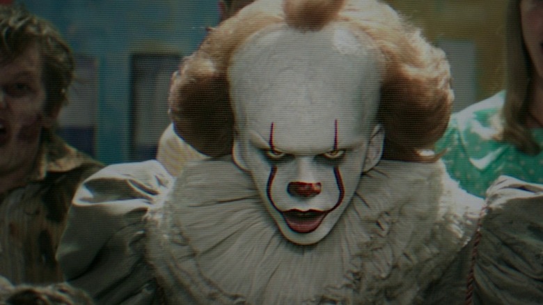 Pennywise taunting his prey through a television set in It (2017)