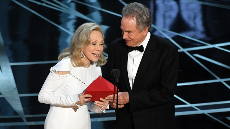 Legendary actors Faye Dunaway and Warren Beatty standing onstage at the Academy Awards, mistakenly announcing "La La Land" as best picture winner