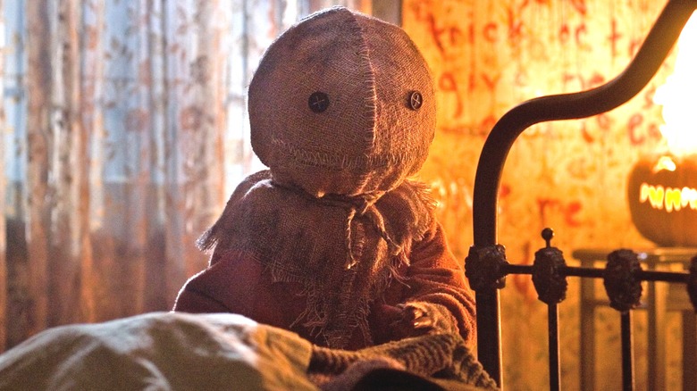 Sam standing by a bed in "Trick 'r Treat."