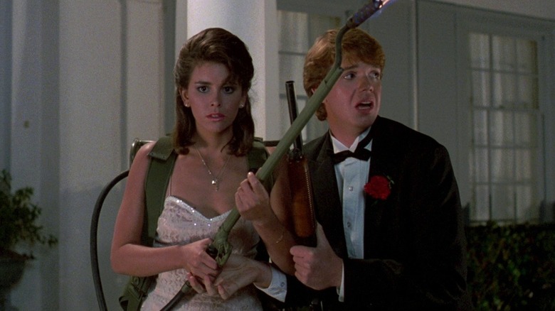 Cythnia and Chris holding a flamethrower in "Night of the Creeps."