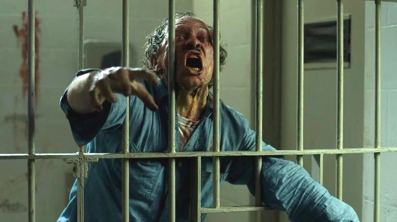A man reaching through jail cell bars in "The Crazies."