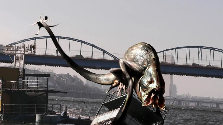 A monster holding someone with its tail in "The Host."