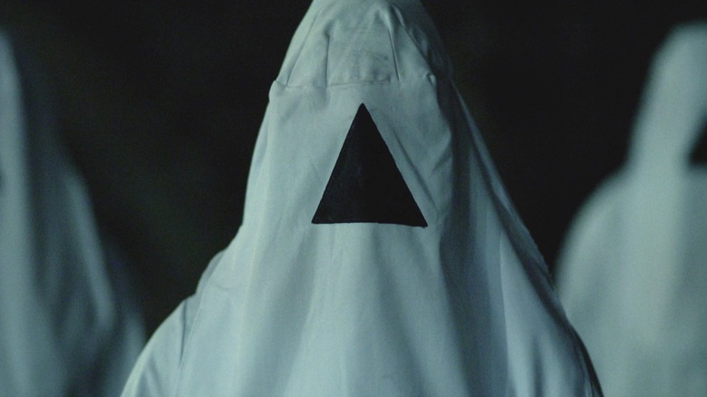 People in white hoods in "The Void."