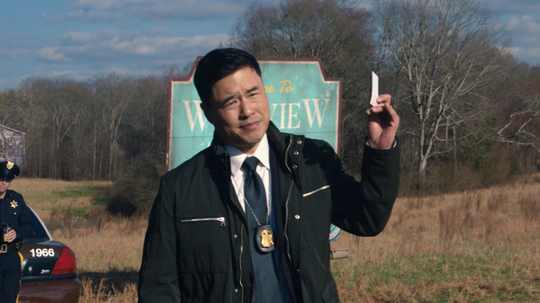 Jimmy Woo holds a card