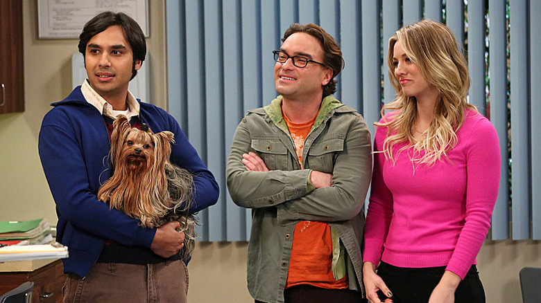 Raj holding Cinnamon next to Leonard and Penny on The Big Bang Theory