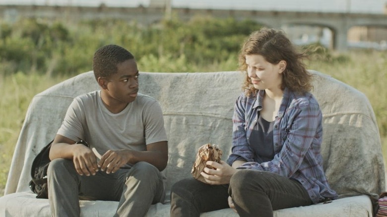 Milo and Sophie sitting on a couch outside in "The Transfiguration."