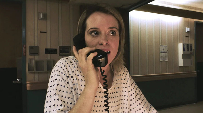 Sawyer wearing a hospital gown and talking on the phone in "Unsane."