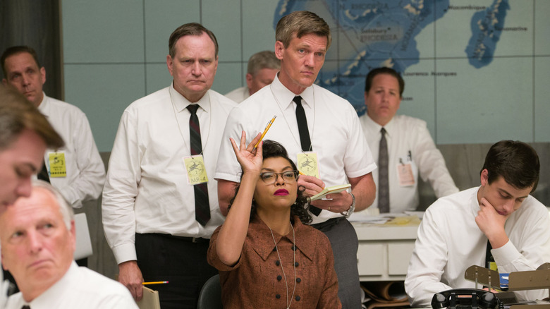 Katherine raises her pencil in NASA meeting in "Hidden Figures" (2016)