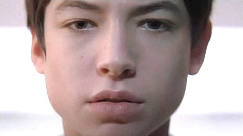 Ezra Miller staring ahead blankly