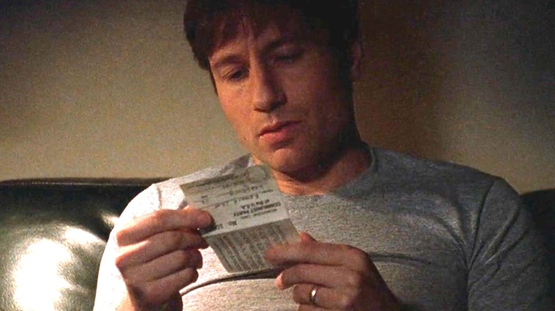 Fox Mulder looking at a document in "The X-Files"