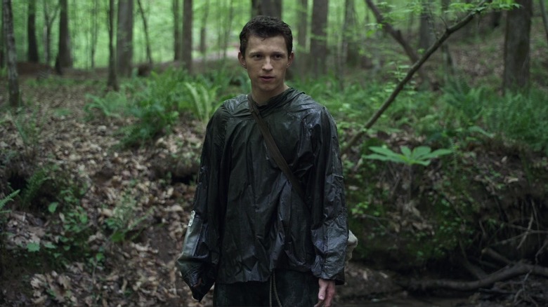 Todd stands in forest