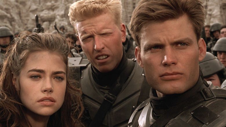 Carmen, Ace, and Rico looking in the same direction in "Starship Troopers"
