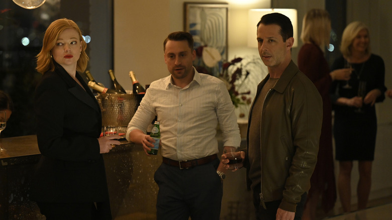 Shiv Roman and Kendall looking at someone at a party on Succession