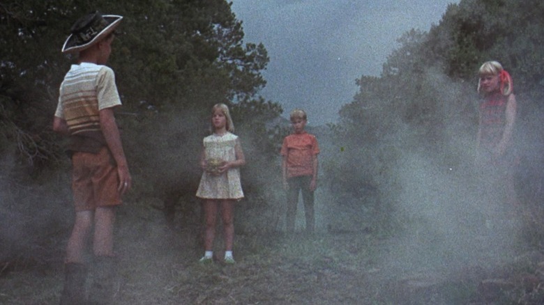 Children stand in a misty forest in "The Brotherhood of Satan" (1971)