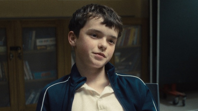 Jamie sits at a table in detention in "Adolescence" (2025)