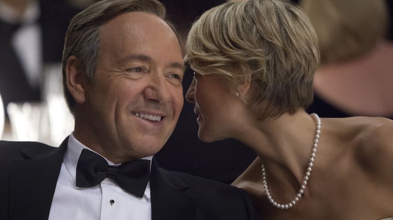 Claire whispering in Frank's ear in "House of Cards."
