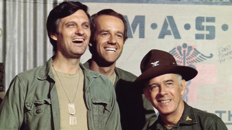 Three men smiling in "M*A*S*H."