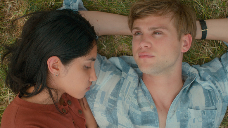 Emma and Leo laying on grass in "One Day."