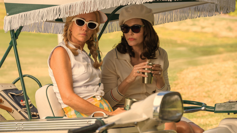 Maxine and Dinah sitting in a golf cart in "Palm Royale."