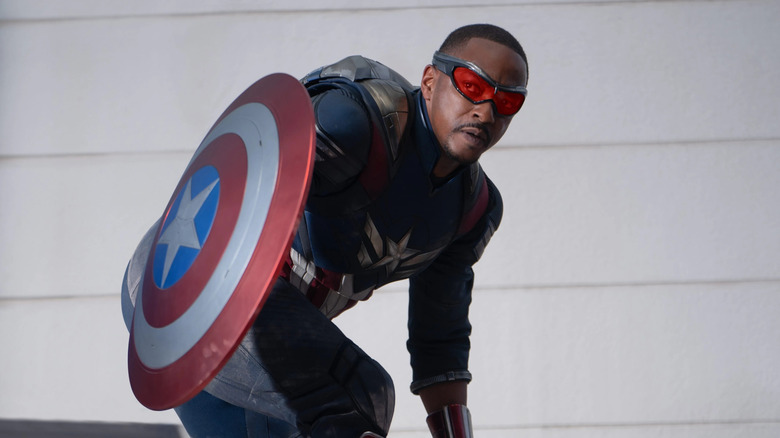 Sam Wilson's Captain America huddles behind his shield in Captain America: Brave New World (2025)