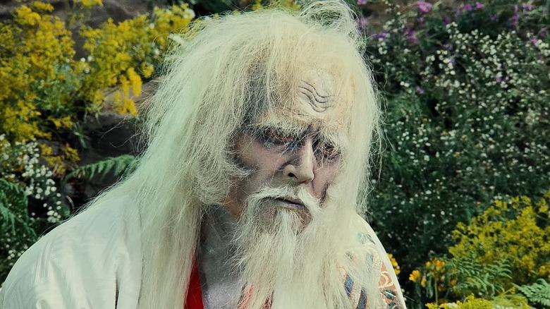 An insane Hidetora Ichimonji sitting in the fields