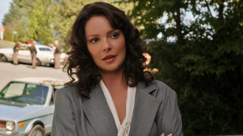 Kate stands in a suit on the lawn in "Firefly Lane" (2021-2023)