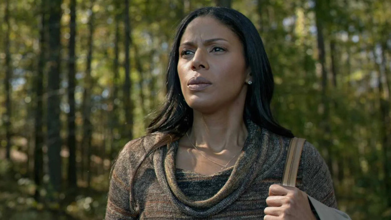 Grace walks calmly through the woods in "Greenleaf" (2016-2020)
