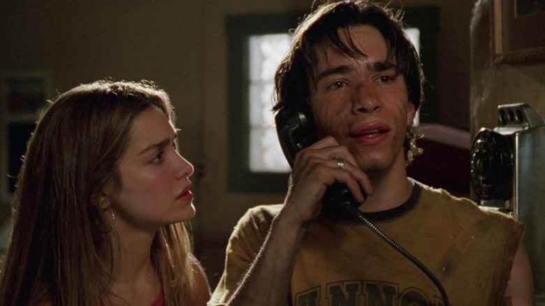 Darry covered in dirt on the phone with Trish looking at him worried