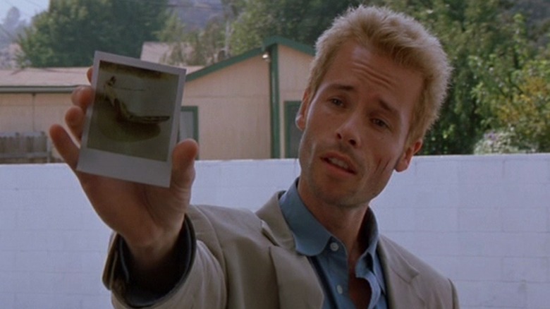 Guy Pearce holds photo