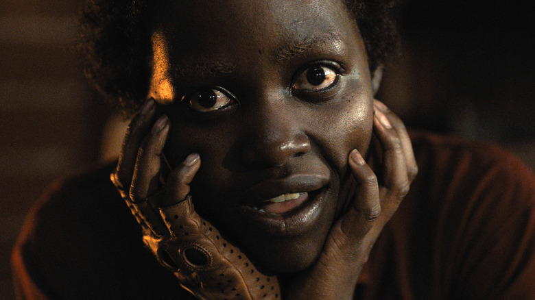 Us' Lupita Nyong'o holding her face