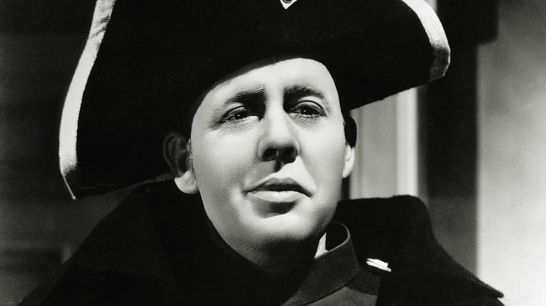 Inspector Javert listens intently in 'Les Miserables' 1935