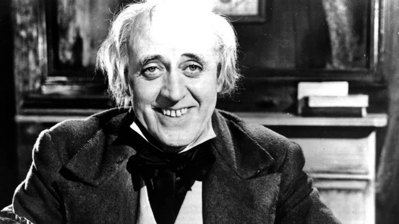 Ebenezer Scrooge smiling in Scrooge