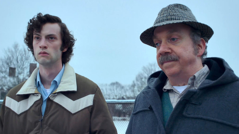 Paul and Angus walk outside in the snow in The Holdovers