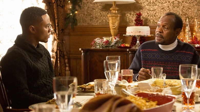 Evan and Walter sitting at a table in "Almost Christmas" (2016)