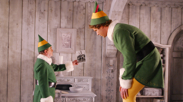 Papa Elf showing Buddy a photograph in "Elf" (2003)